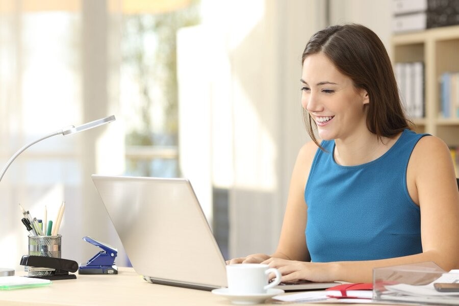 A woman working from her home office’s desk.